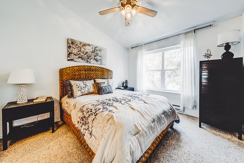 Modern bedroom with elegant bedding in Bella Vista Apartments