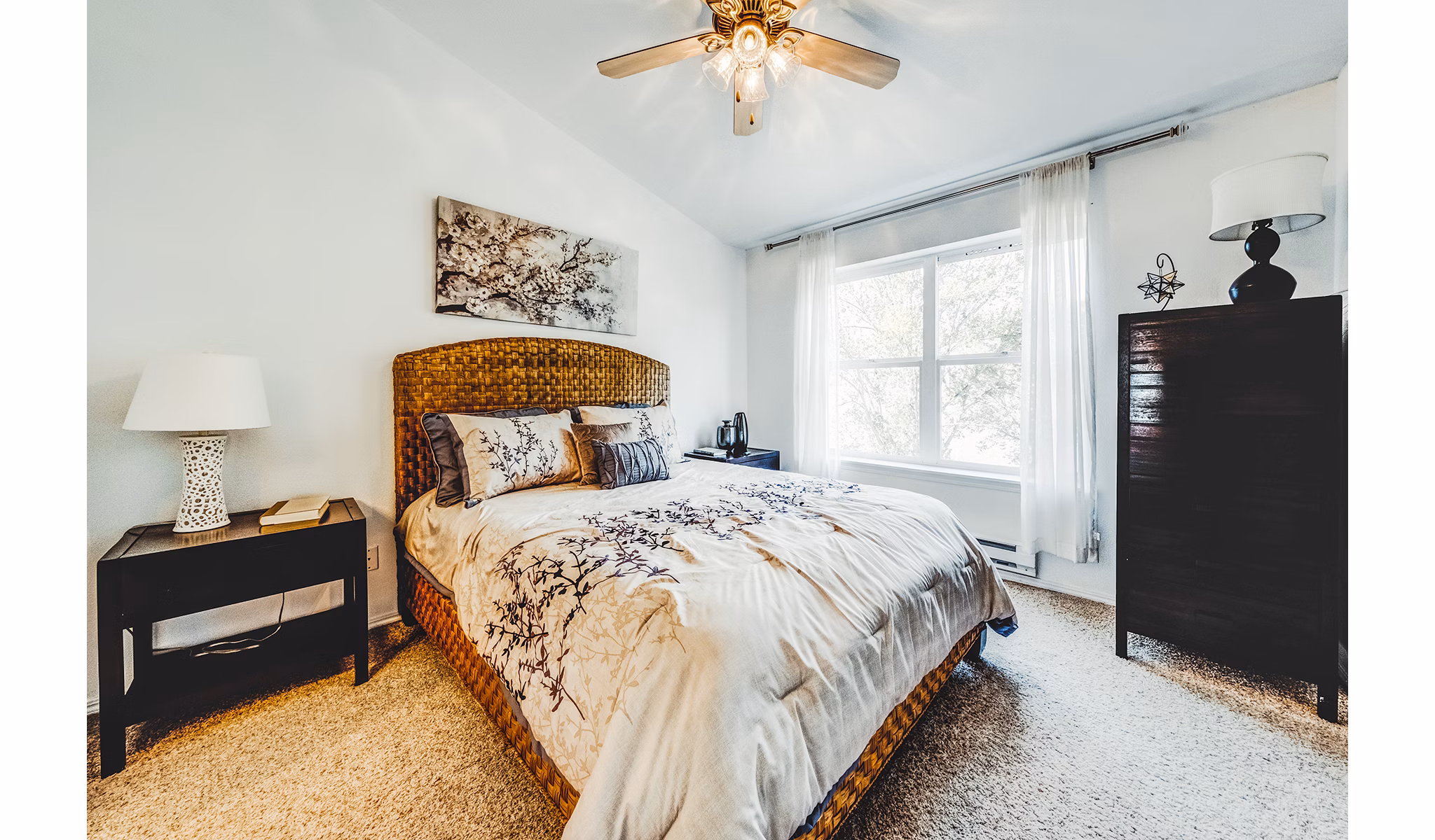 Modern bedroom with elegant bedding in Bella Vista Apartments