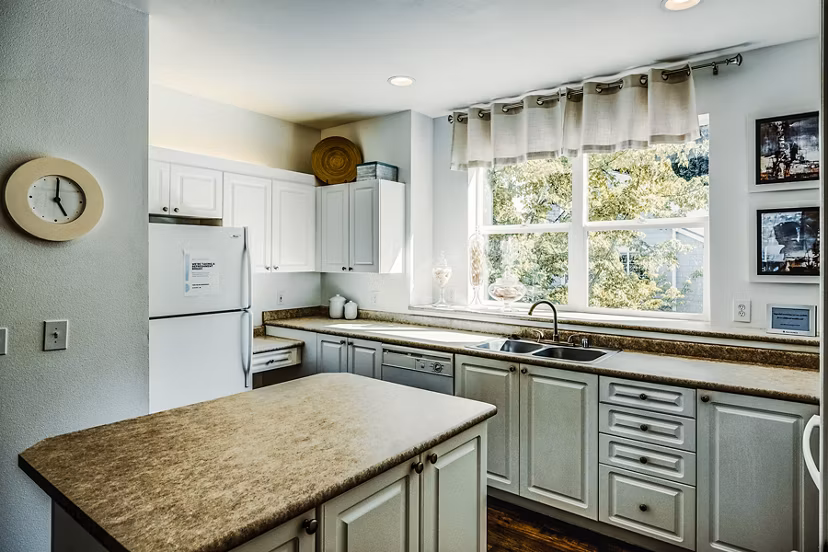 Modern kitchen with stainless steel appliances in Bella Vista luxury apartments