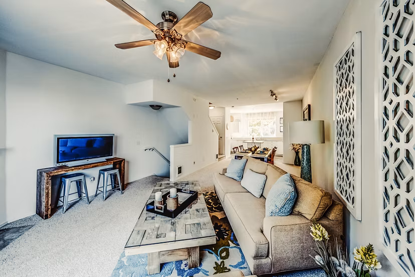 Spacious living room with modern decor and large windows in Bella Vista Apartments