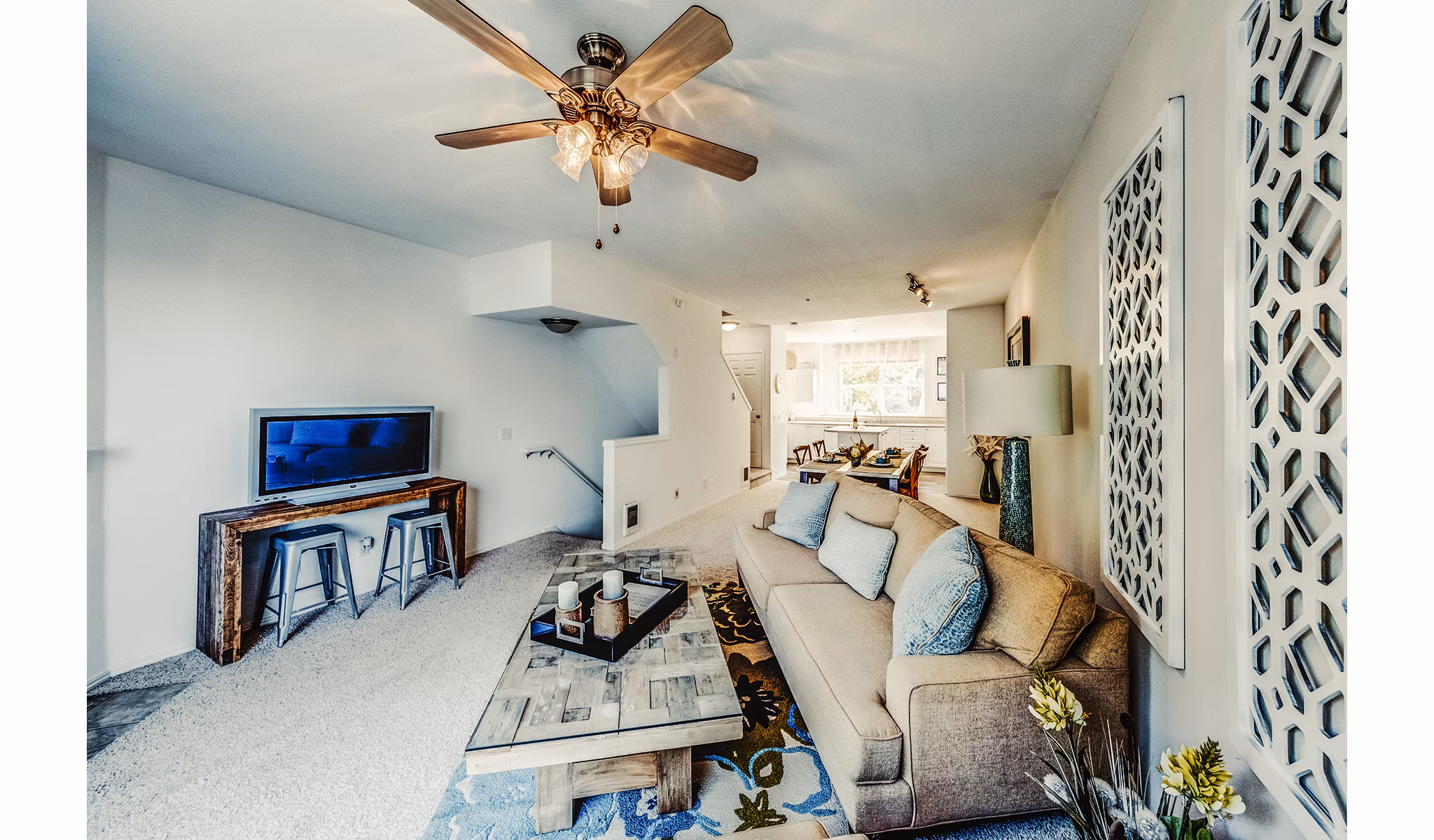 Spacious living room with modern decor and large windows in Bella Vista Apartments