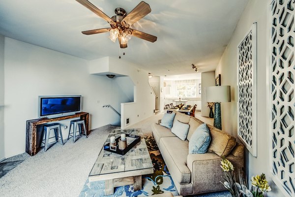 Spacious living room with modern decor and large windows in Bella Vista Apartments