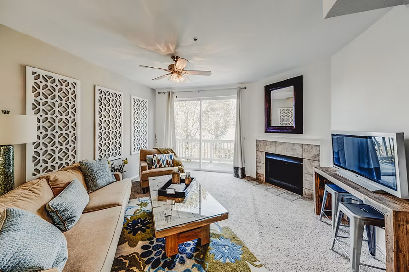 Bella Vista Apartments: Modern living room with chic decor and large windows offering natural light