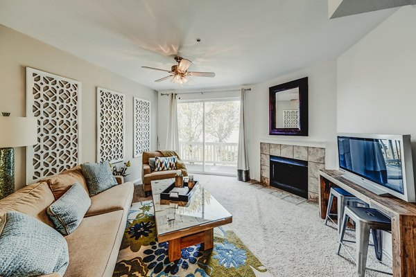 Bella Vista Apartments: Modern living room with chic decor and large windows offering natural light