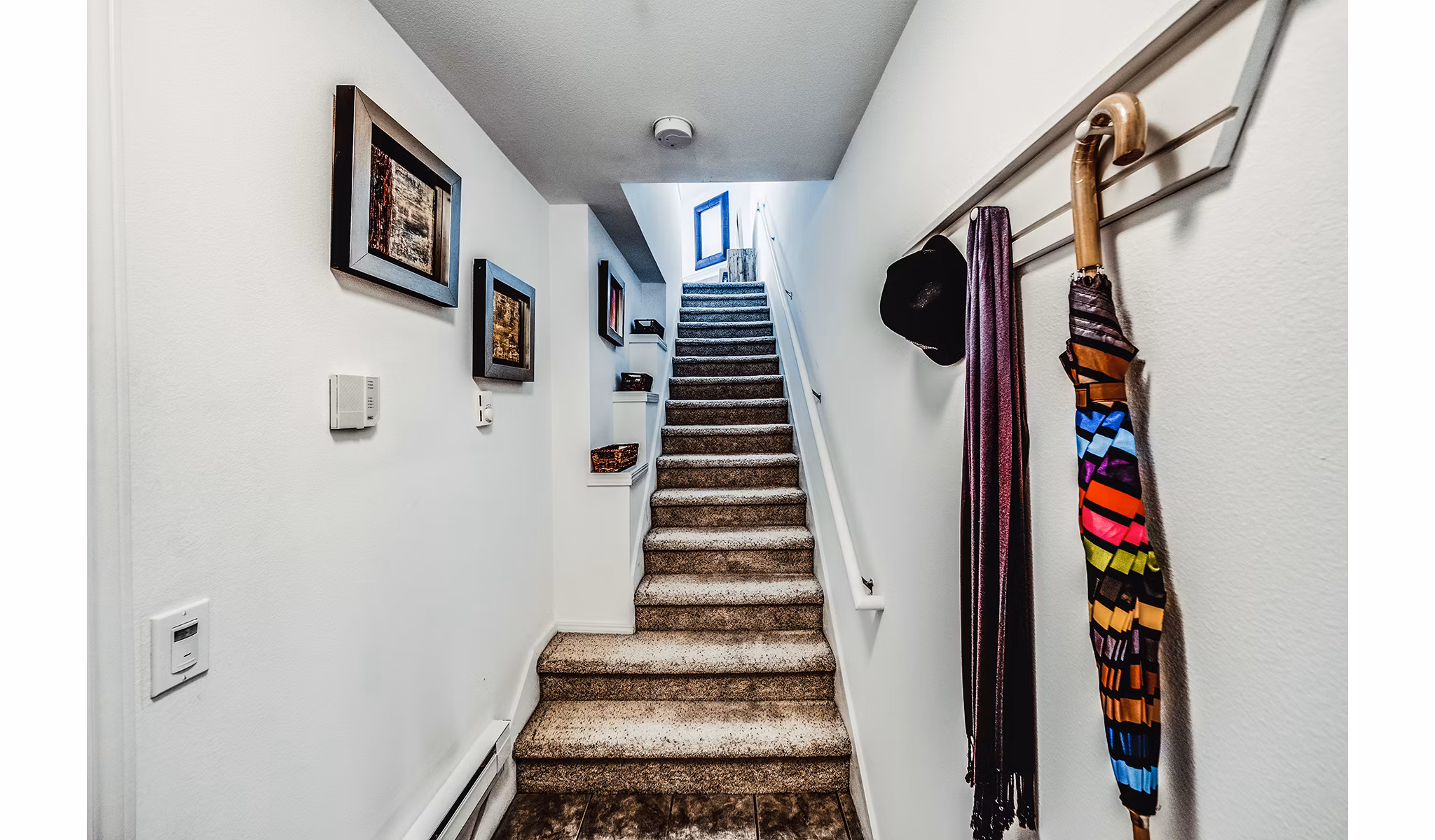 Hallway with modern staircase at Bella Vista Apartments
