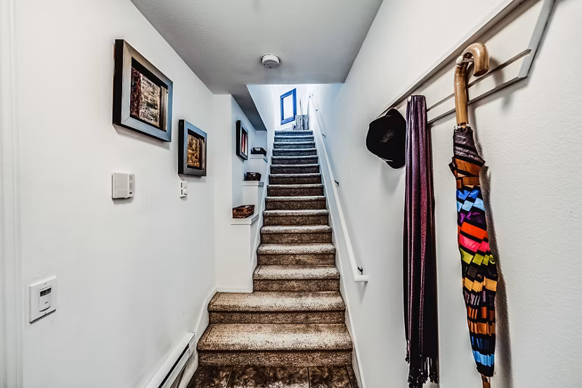 Hallway with modern staircase at Bella Vista Apartments
