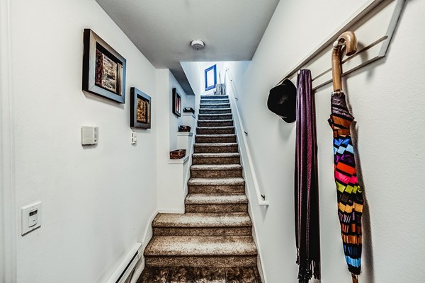Hallway with modern staircase at Bella Vista Apartments