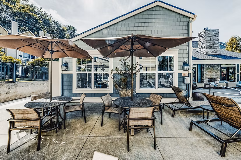Resort-style pool patio with lounge chairs at Bella Vista Apartments, perfect for relaxation and socializing