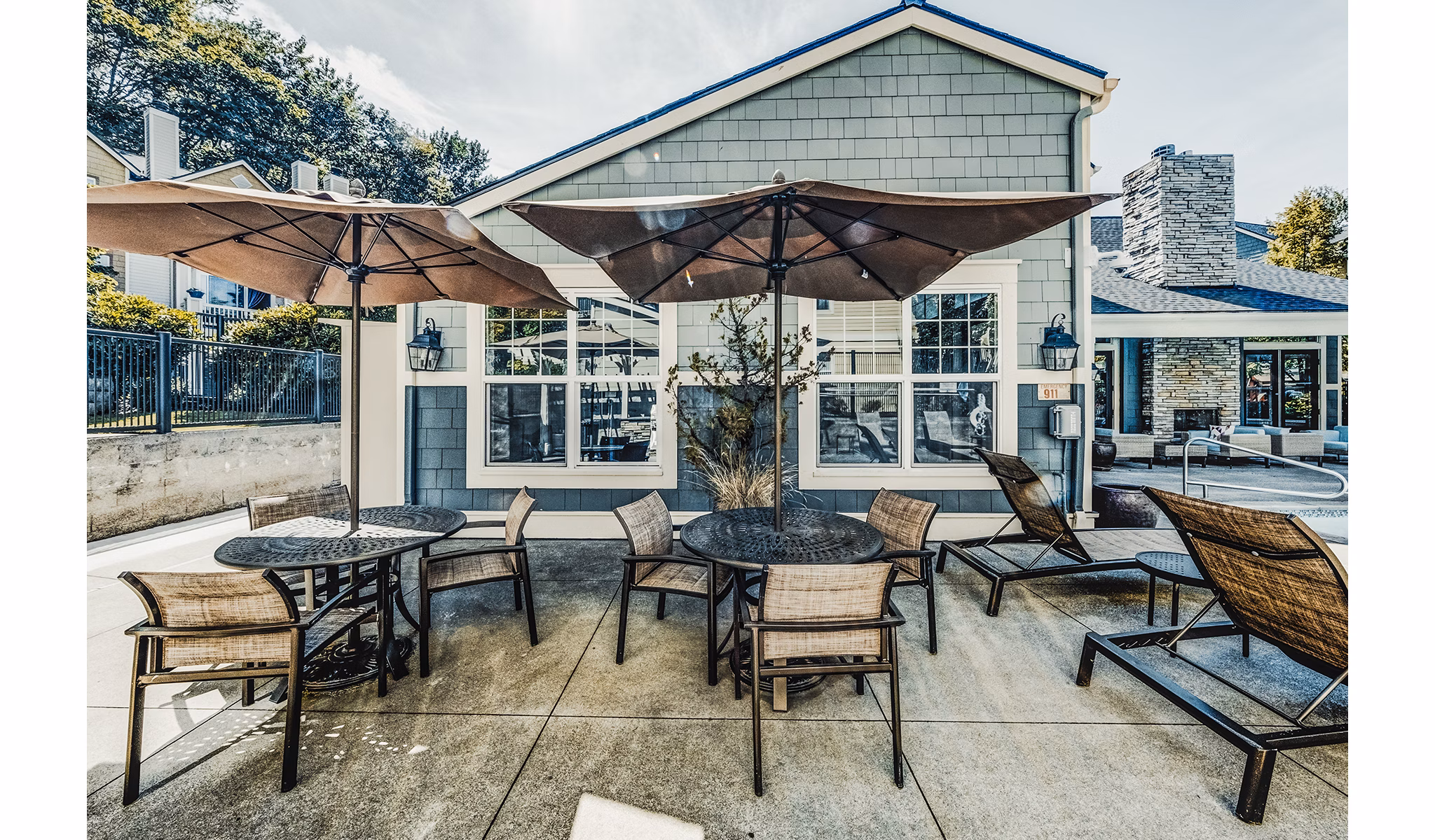 Resort-style pool patio with lounge chairs at Bella Vista Apartments, perfect for relaxation and socializing