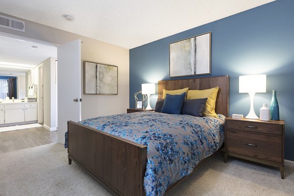 Spacious bedroom with modern furnishings at La Terraza Apartments, a luxury Greystar property