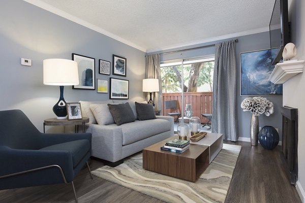 La Terraza Apartments: Cozy living room with modern decor and large windows