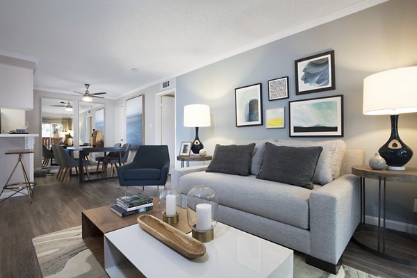 Spacious living room with modern dÃ©cor and large windows in La Terraza Apartments
