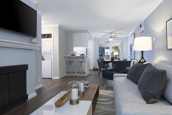 Spacious living room featuring modern furnishings and large windows at La Terraza Apartments, a luxury Greystar community