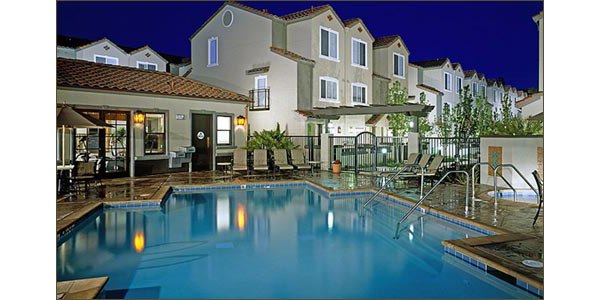 Scenic outdoor pool with sun loungers at La Terraza Apartments, offering relaxation and leisure in a luxury living environment