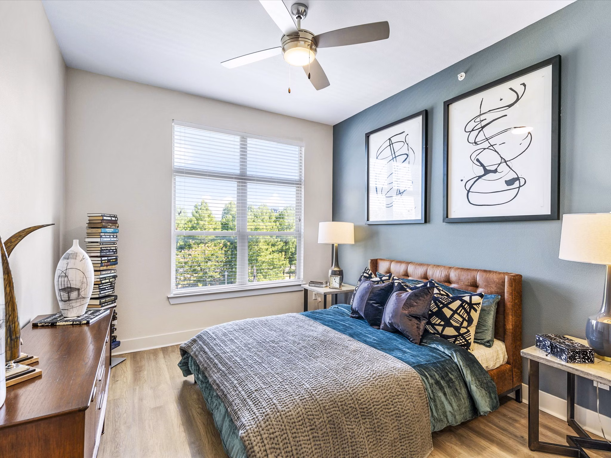 Modern bedroom with sleek design and large windows in Ambrose Apartments, a luxury location by Greystar