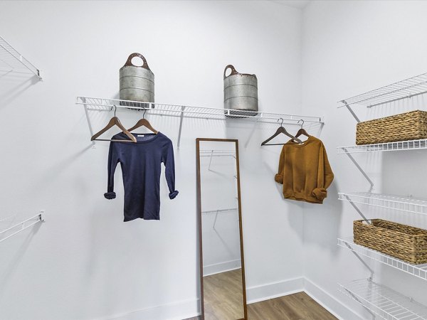 Spacious bedroom closet with built-in shelving at Ambrose Apartments, perfect for stylish organization in Greystar luxury apartments