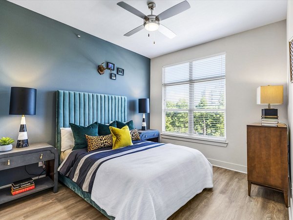 Cozy bedroom with stylish decor at Ambrose Apartments, Greystar's luxury living space in prime location
