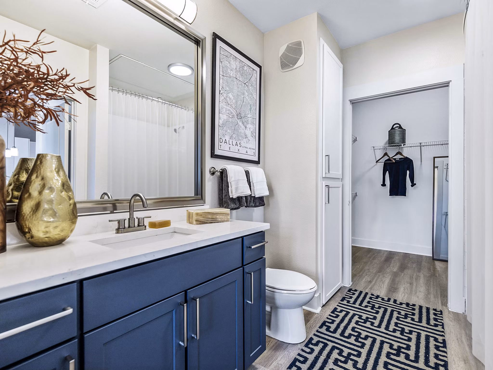 Modern bathroom with sleek fixtures in Ambrose Apartments featuring a spacious vanity and elegant tile design