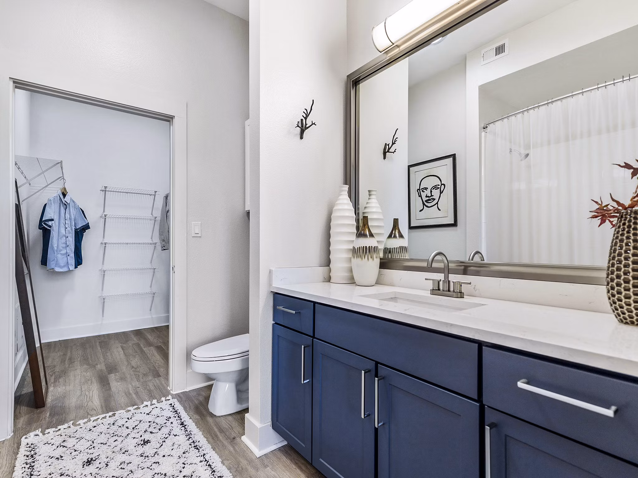 Modern bathroom with dual sinks and sleek fixtures at Ambrose Apartments