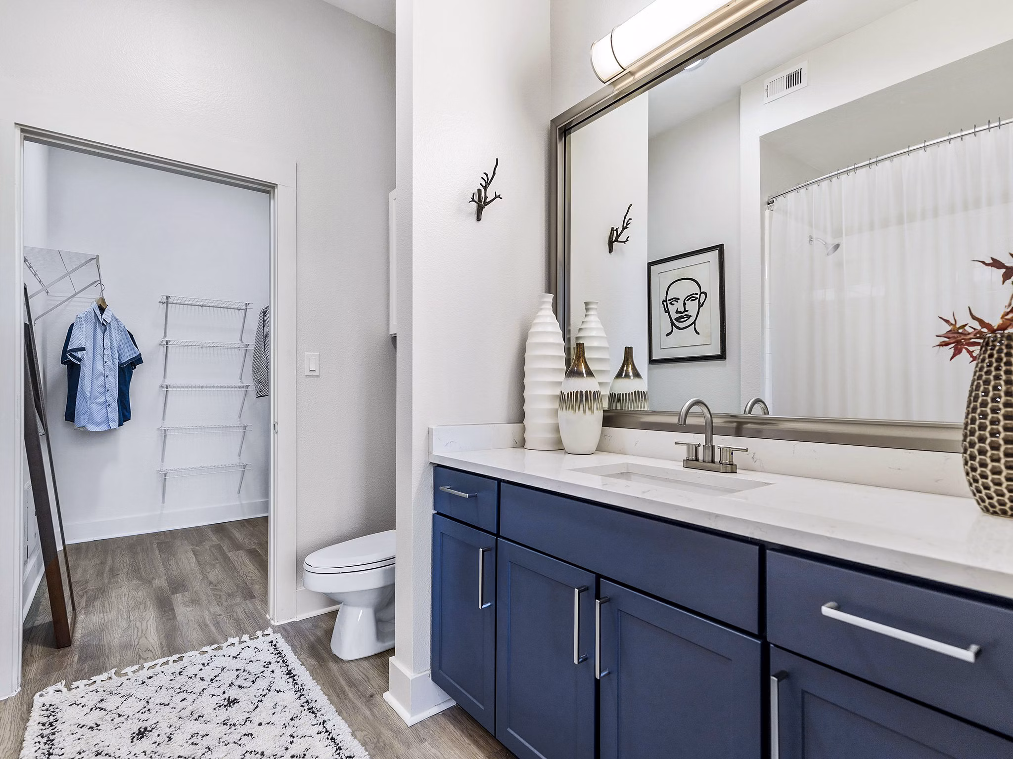 Modern bathroom with dual sinks and sleek fixtures at Ambrose Apartments