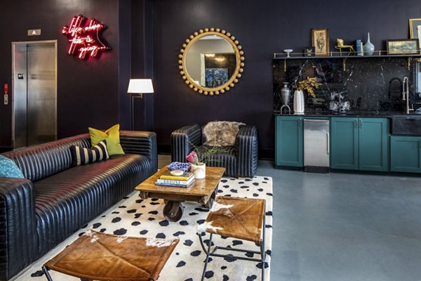 Modern clubhouse with stylish seating and game area at Broadstone Ambrose Apartments