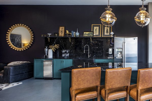 Broadstone Ambrose Apartments: Modern clubhouse with seating areas and pool table, offering luxury amenities in a vibrant community