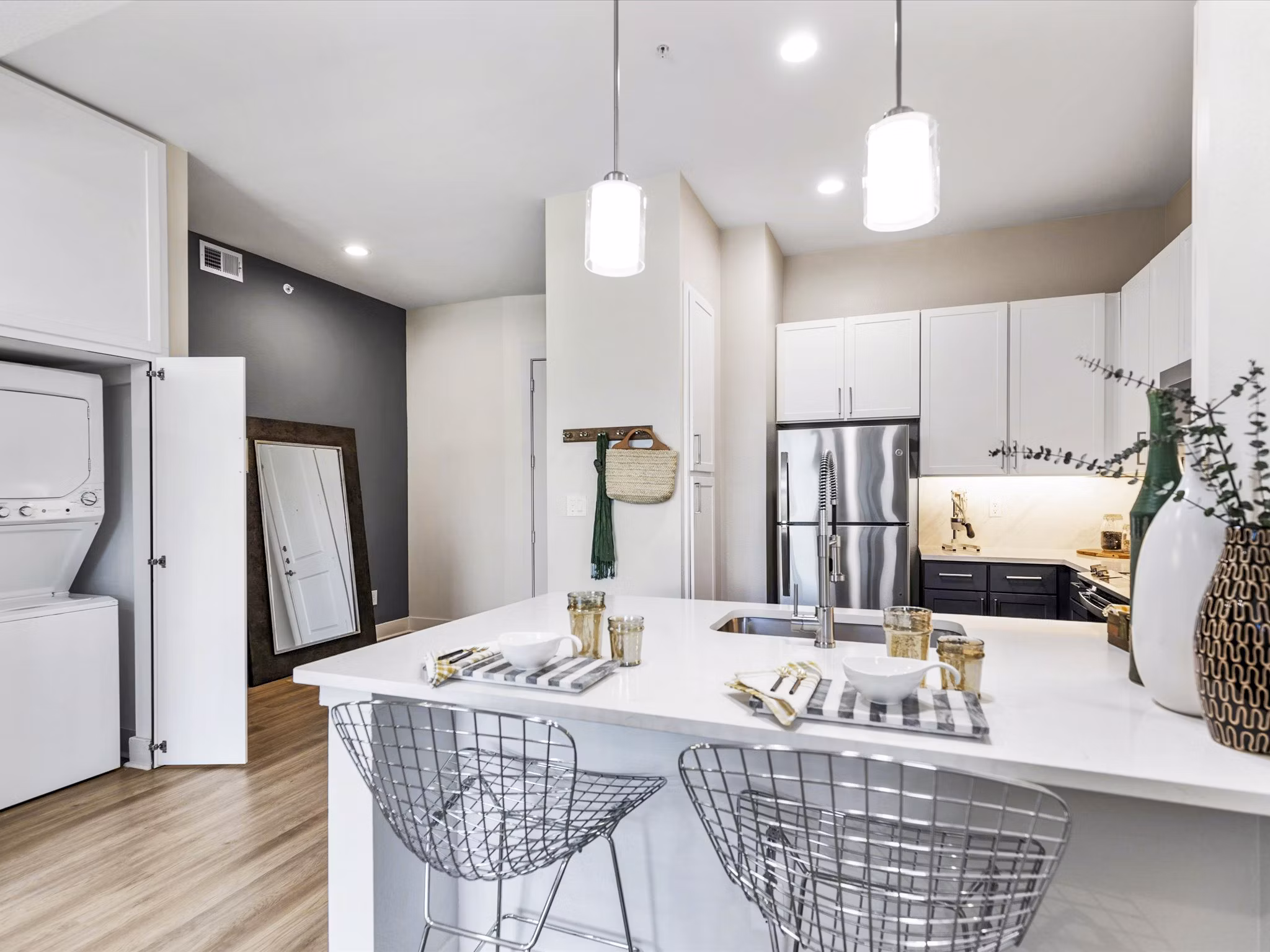 Modern kitchen with granite countertops and stainless steel appliances in Ambrose Apartments' luxury community
