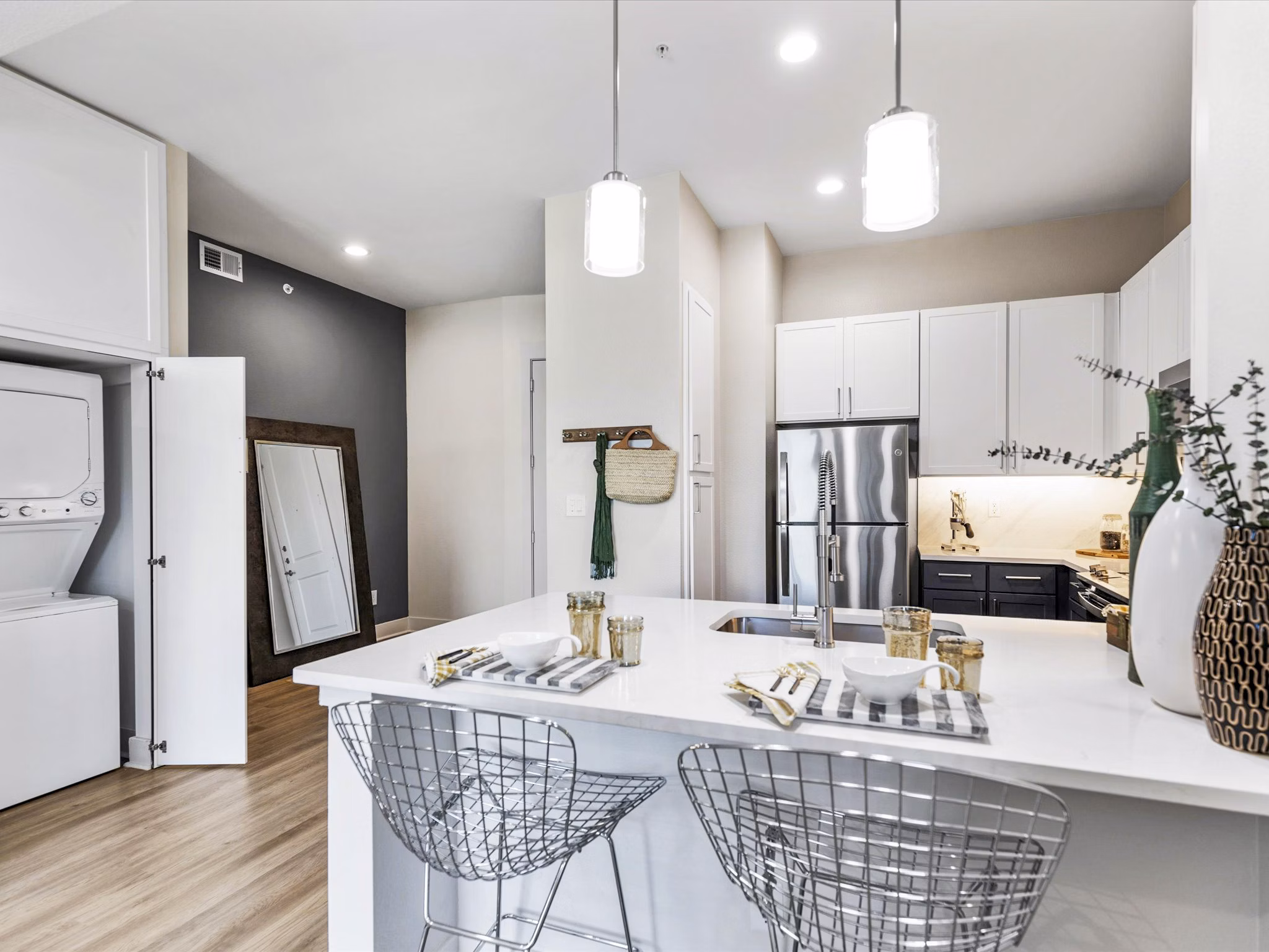 Modern kitchen with granite countertops and stainless steel appliances in Ambrose Apartments' luxury community