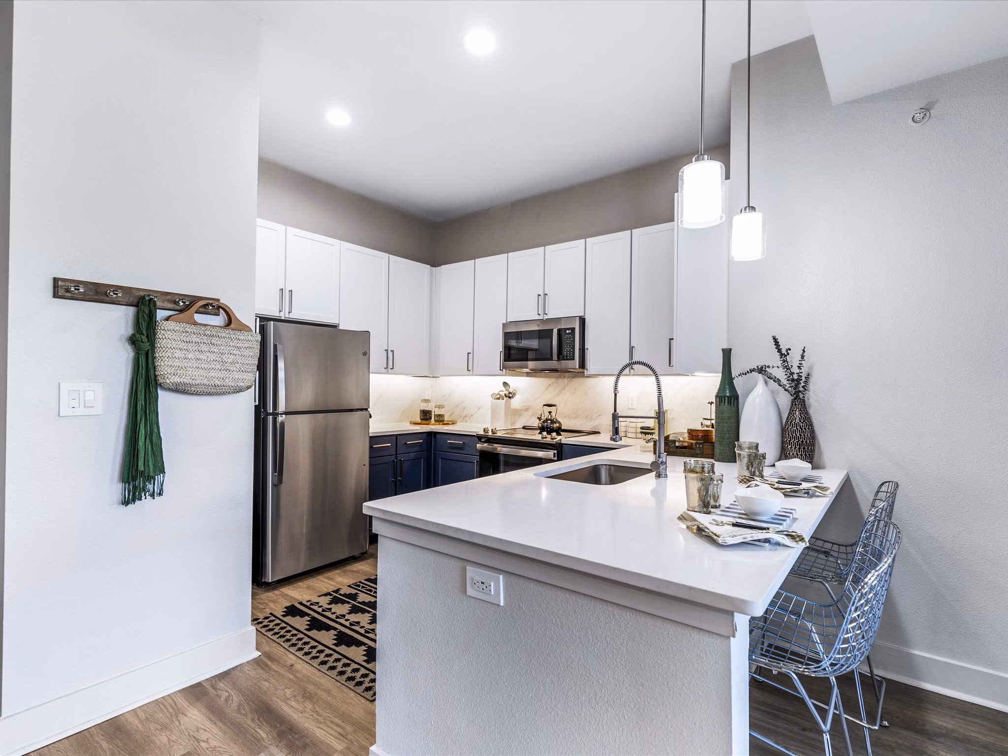 Modern kitchen with stainless steel appliances and granite countertops at Ambrose Apartments
