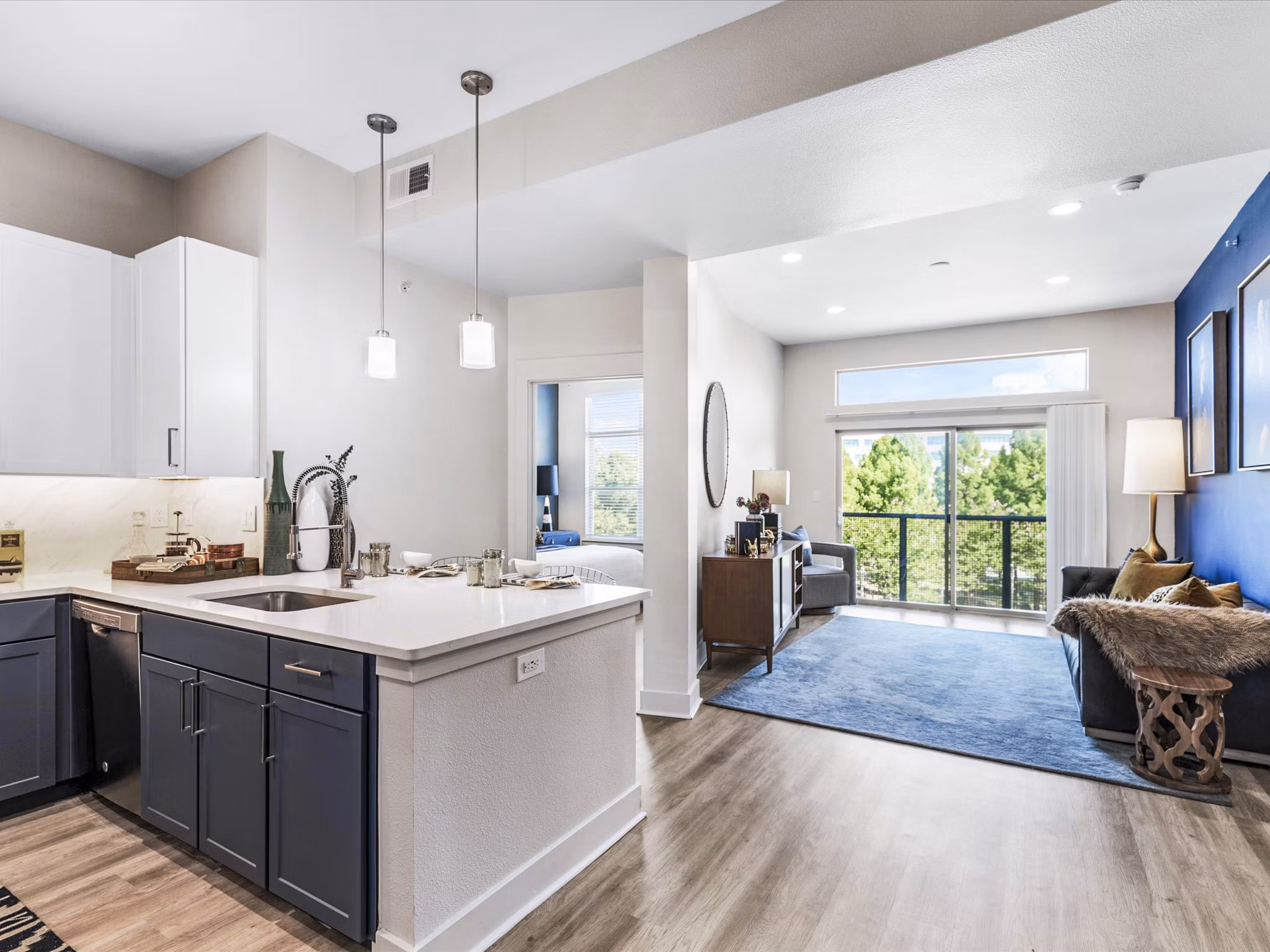 Cozy living room with modern furniture and large windows at Ambrose Apartments, featuring luxury amenities for comfortable living in a Greystar community