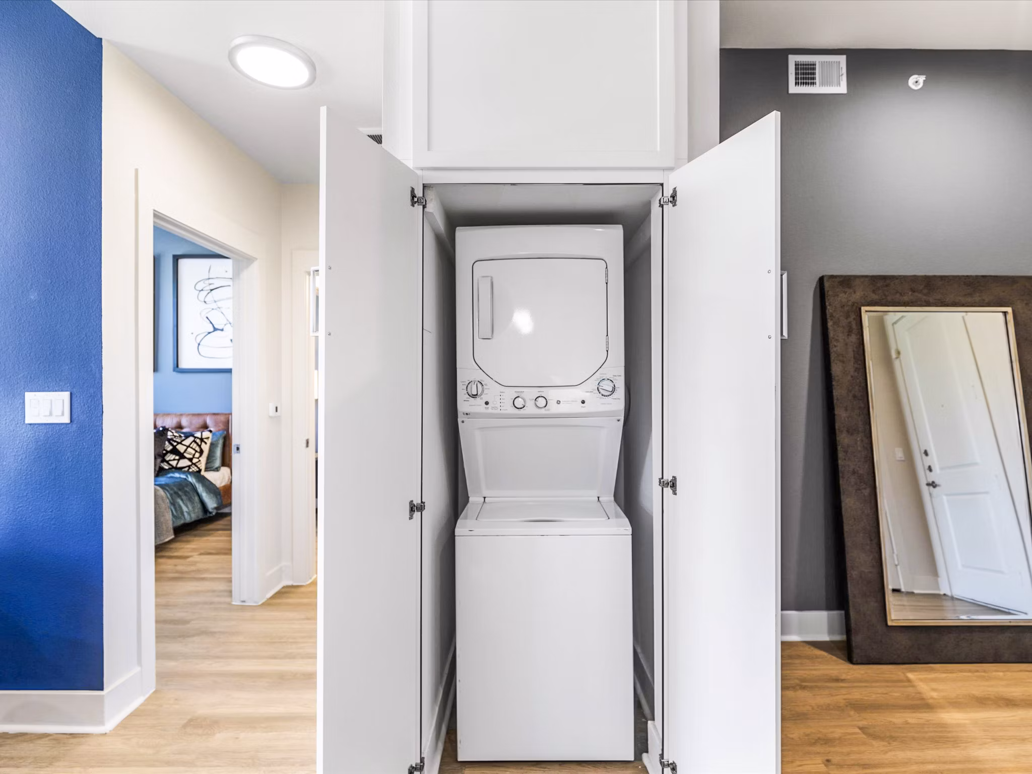 Laundry room featuring modern appliances at Ambrose Apartments