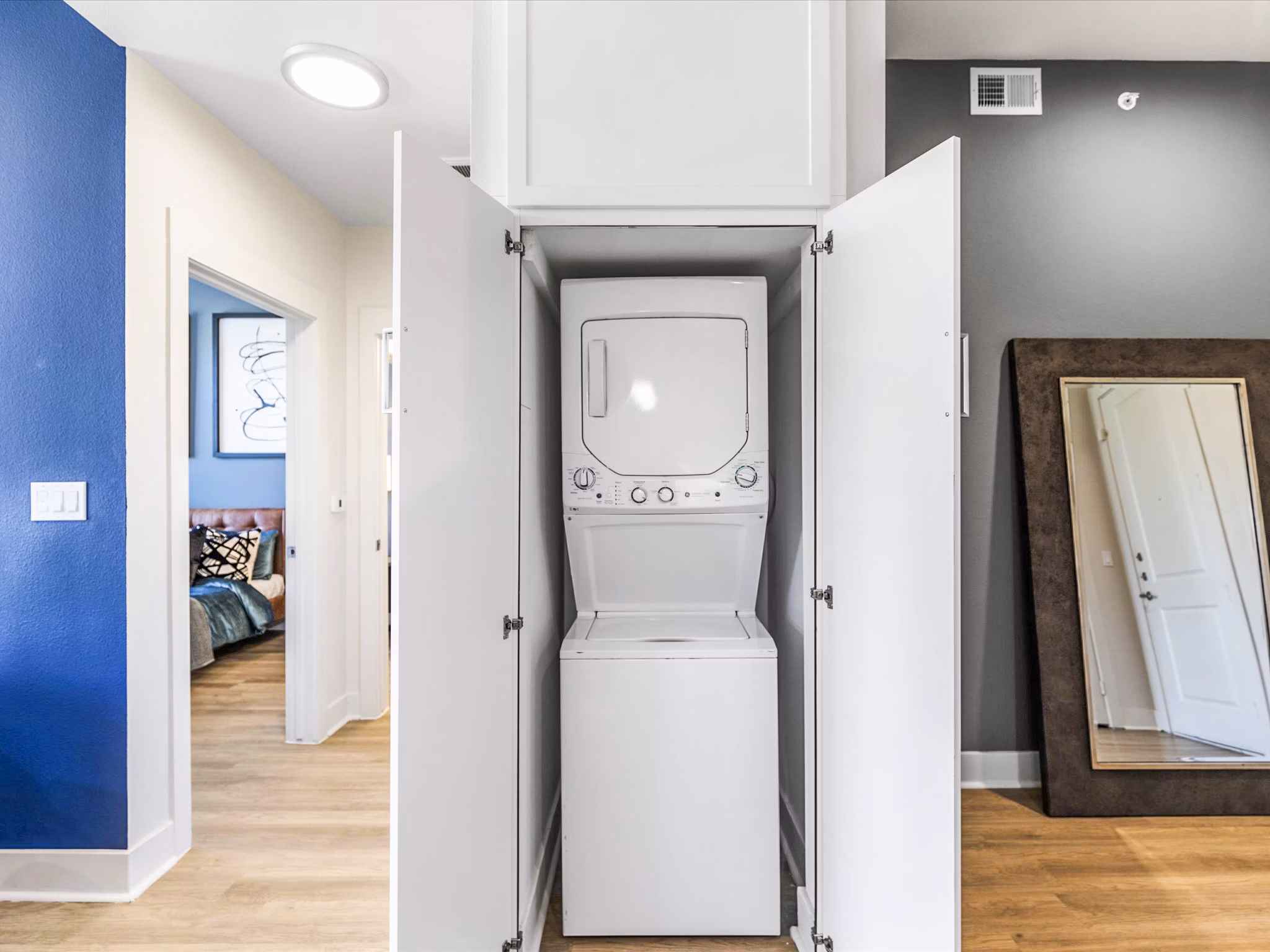 Laundry room featuring modern appliances at Ambrose Apartments