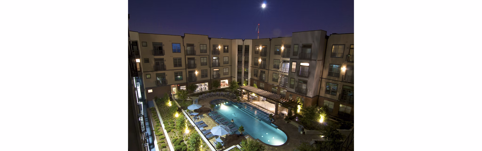 Luxe poolside retreat at Broadstone Ambrose Apartments with cabanas and sun loungers