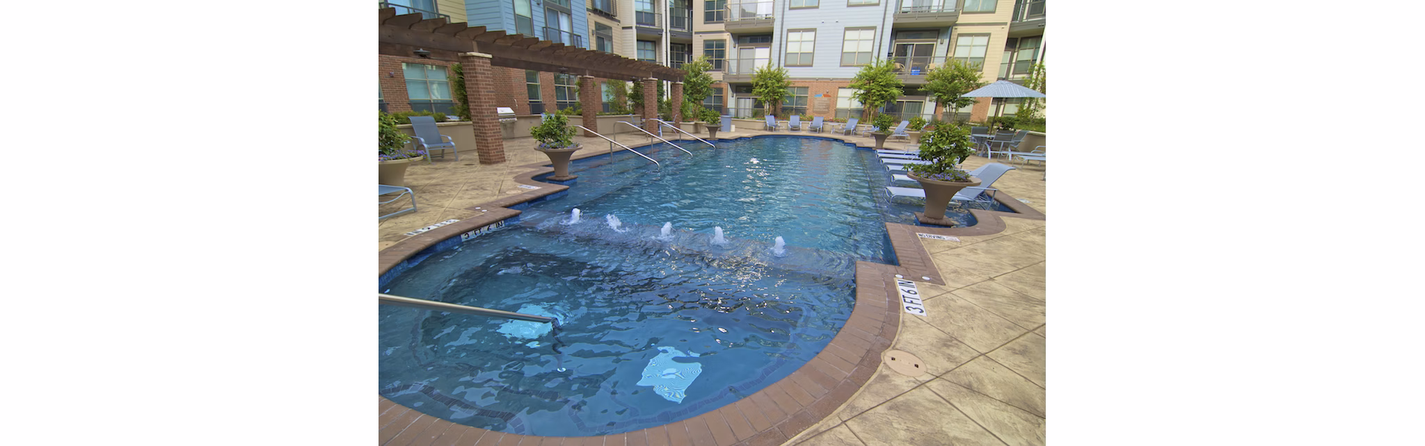 Resort-style pool at Broadstone Ambrose Apartments, offering luxury relaxation and amenities in a vibrant community setting