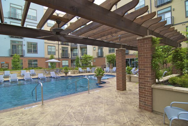Rooftop pool with lounge chairs at Broadstone Ambrose luxury apartments, perfect for relaxation and leisure activities