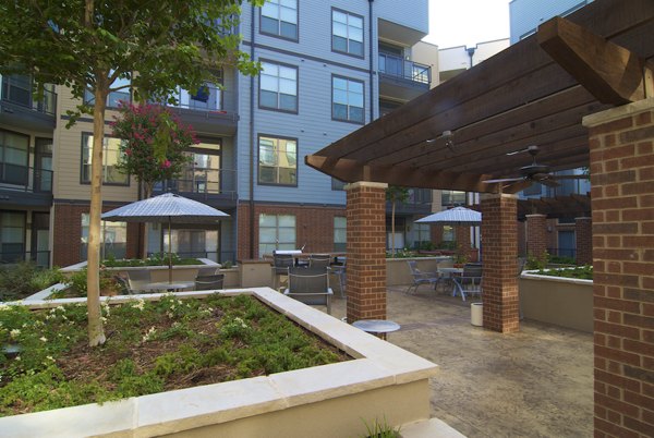 Grill area with modern seating at Broadstone Ambrose Apartments, a Greystar luxury community