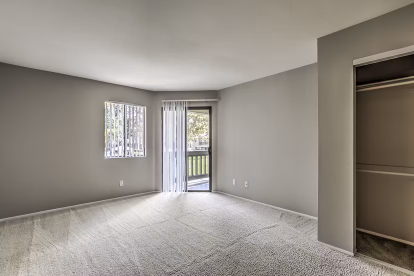 Elegant bedroom with plush bedding at Flower Fields Apartments, a Greystar luxury community