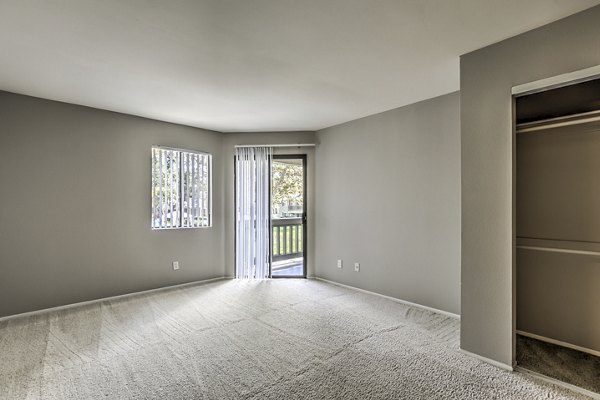 Elegant bedroom with plush bedding at Flower Fields Apartments, a Greystar luxury community