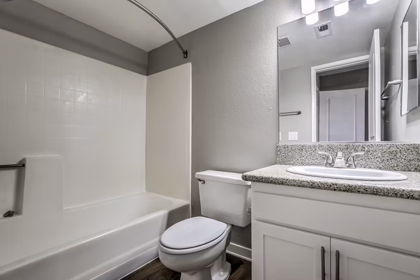Modern bathroom with marble countertops at Flower Fields Apartments, luxurious living experience in a vibrant community setting