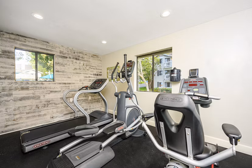 Fitness center with modern equipment at Flower Fields Apartments for an active lifestyle