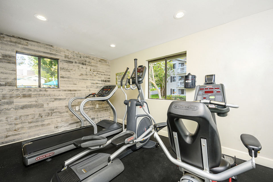 Fitness center with modern equipment at Flower Fields Apartments for an active lifestyle