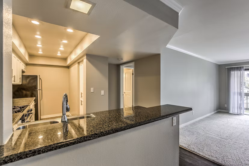Modern kitchen with stainless steel appliances at Flower Fields Apartments