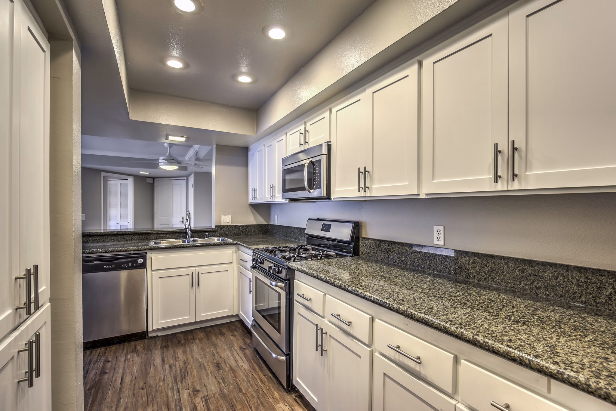 Modern kitchen with stainless steel appliances at Flower Fields Apartments