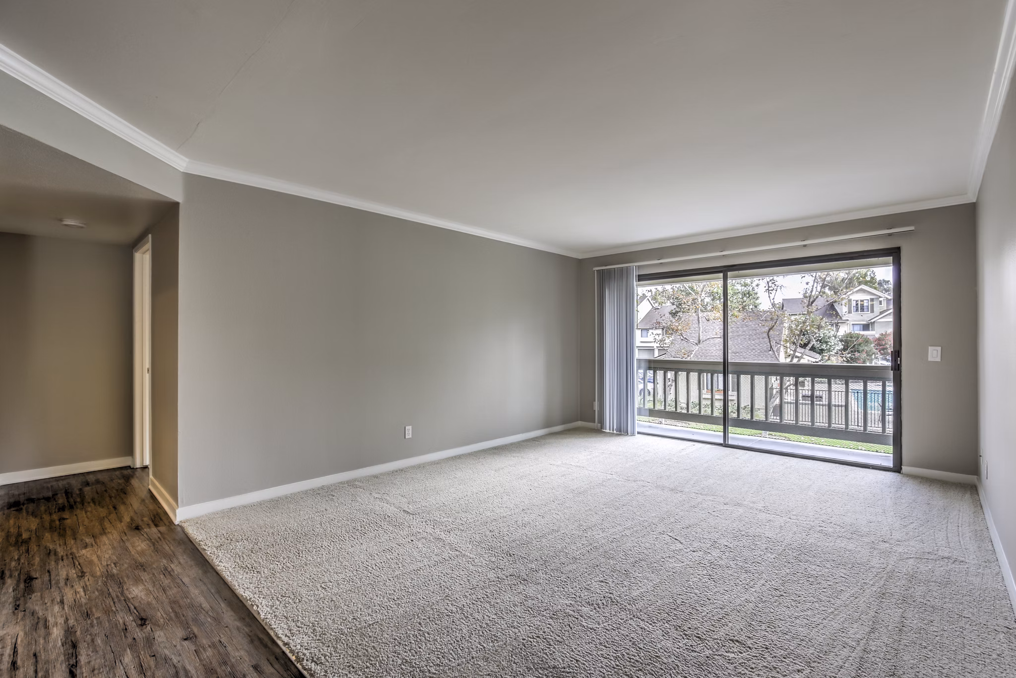 Cozy living room with plush seating and natural light at Flower Fields Apartments