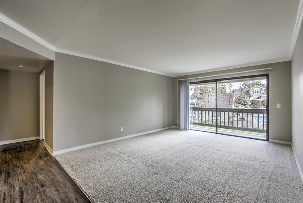 Cozy living room with plush seating and natural light at Flower Fields Apartments