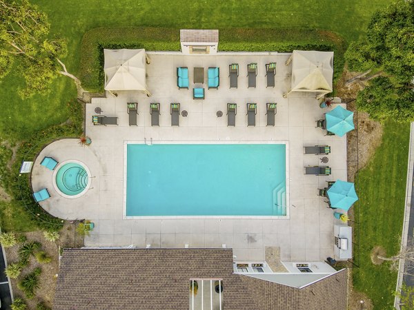 Pool with sundeck at Flower Fields Apartments, a luxury property by Greystar in a serene landscape