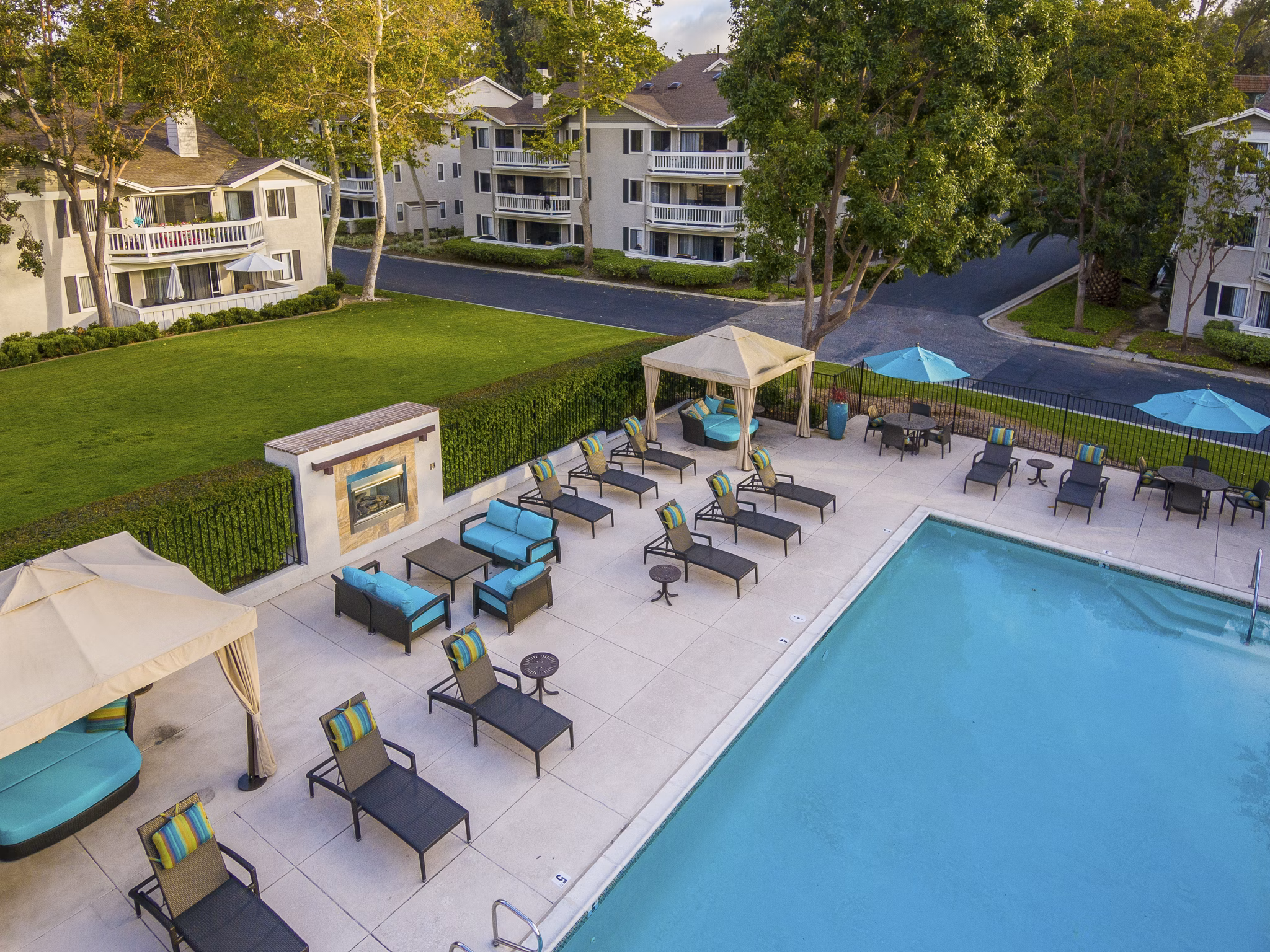 Luxury swimming pool with sun loungers at Flower Fields Apartments, ideal for relaxation and leisure activities