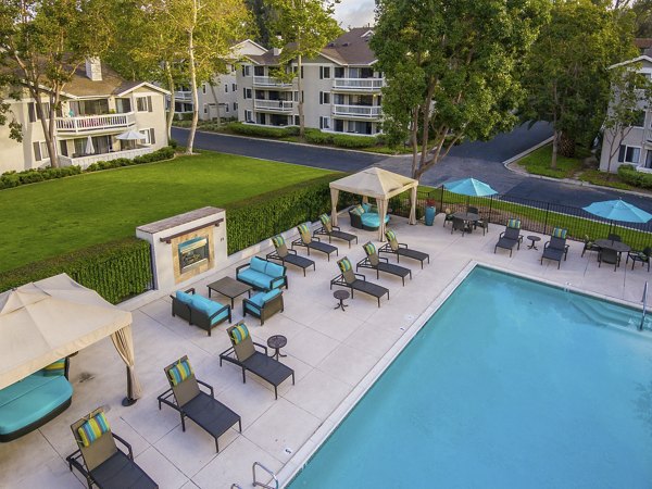 Luxury swimming pool with sun loungers at Flower Fields Apartments, ideal for relaxation and leisure activities