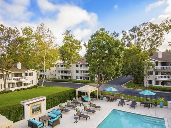 Infinity pool with lush landscaping at Flower Fields Apartments, offering luxury leisure for residents