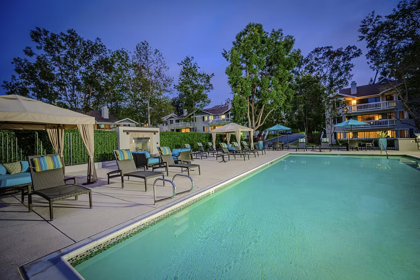 Relaxing pool area at Flower Fields Apartments offering luxury amenities